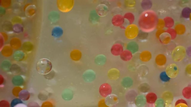 Multicolored hydrogel balls. Movement: fall, bounce