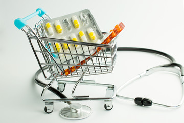 Tablets in the shopping cart on a white background. Big sale of tablets. Stethoscope on a white background..