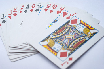 deck of playing cards lying on a white background