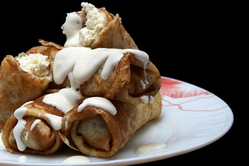 Homemade thin pancakes with cottage cheese and sour cream, very tasty and healthy food.