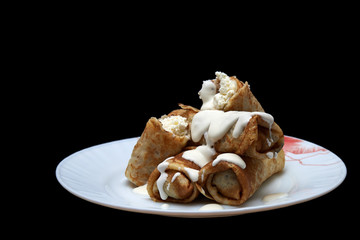 Homemade thin pancakes with cottage cheese and sour cream, very tasty and healthy food.