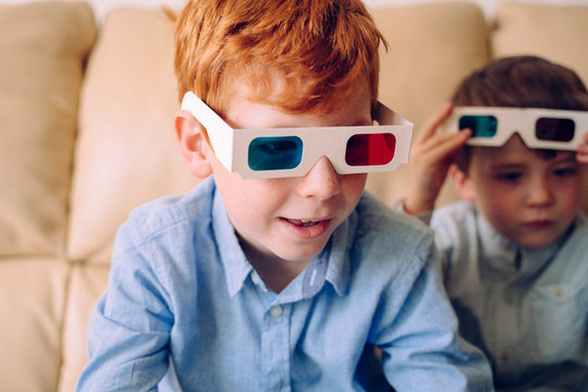 Curious Little Boy Wearing Three Dimensional Glasses And Reading An Interactive Book At Home. Educational Books And Learning Activities For Intellectually Active Children. Experience New Sensations.