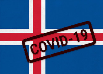 Flag of Iceland on paper texture with stamp, banner of Coronavirus name on it. 2019 - 2020 Novel Coronavirus (2019-nCoV) concept, for an outbreak occurs in the Iceland.