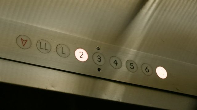 Elevator floor sign indicator lights turn on as elevator climbs floors