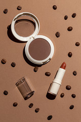 Cosmetics composition decorated with coffee beans top view.