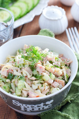 Smoked chicken salad with fresh cucumber in a white bowl, selective focus