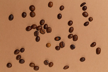 Top view coffee beans on deep beige paper background.