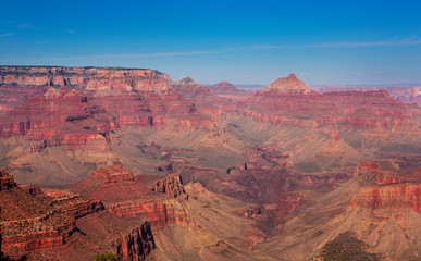 Fototapeta na wymiar Red rocks of Grand Canyon with sun and blue sky, USA