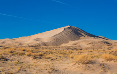 Sand dunes of Kelso in Mojave National Park with blue sky