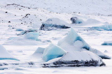 An ancient piece of ice from a glacier, white and blue before reaching the sea