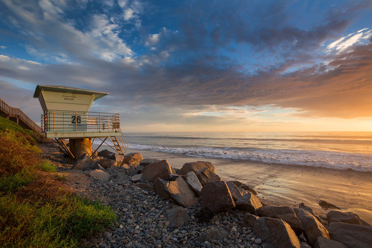 Sunset at beach od West Coast in California with lifeguard tower, USA