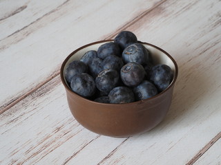Blueberries In Bowl On Wooden Background