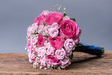 round bouquet of roses on the background of wooden boards