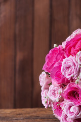 round bouquet of roses on the background of wooden boards