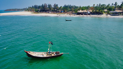 NGWE SAUNG/MYANMAR - MARCH 14, 2020 : Burmese fishermen bear caught fish in baskets on the beach Ngwe Saung Myanmar