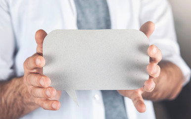 Man holding an empty speech bubble