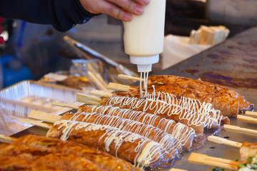 出店のソースをかけている、はしまき	