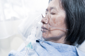 An old asian patient having viral pneumonia were treated with oxygen mask in the hospital