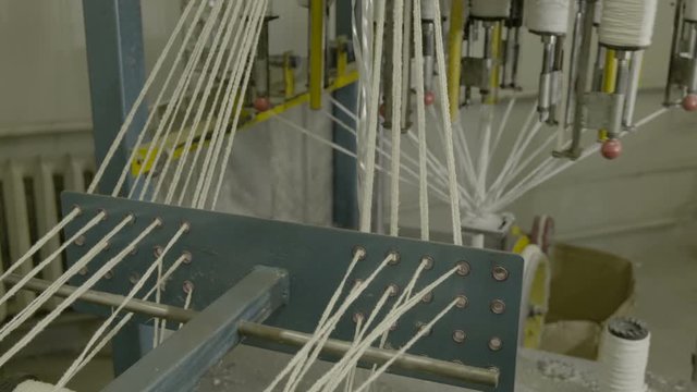 Industrial textile factory. Coils with threads in production.