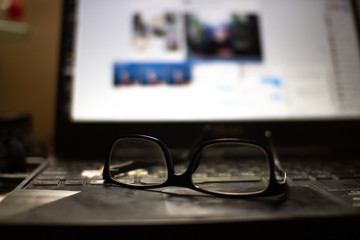 glasses and pen on laptop