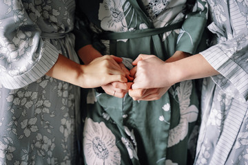 hands of a young woman holding hands