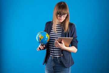 travel agent girl with passports tickets and globe on a blue background. travel concept