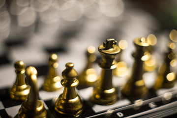 Chess figures on a dark background with smoke and fog. Selective focus