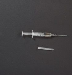 syringe on black background