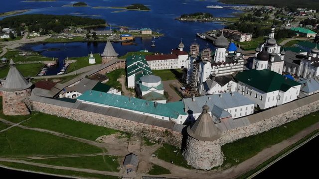 A slow flight near the walls and towers of the Solovetsky Kremlin on a cloudy day with soft lighting. This is part of the fortress of the Solovetsky monastery - an old (1420) ROC monastery.