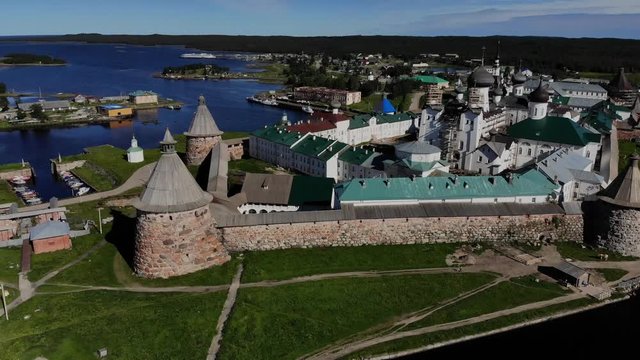 A slow flight near the walls and towers of the Solovetsky Kremlin on a cloudy day with soft lighting. This is part of the fortress of the Solovetsky monastery - an old (1420) ROC monastery.