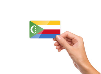 Beautiful hand holding Comoros flag card on white background