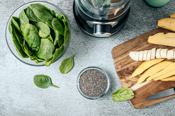 Still life with blender and ingredients on the table to make a spinach smoothie