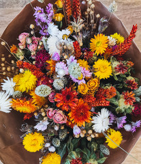 Vibrant dried flower arrangement in red and yellow