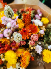 Vibrant dried flower arrangement in red and yellow