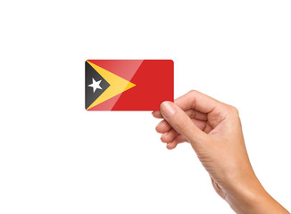 Beautiful hand holding East Timor flag card on white background