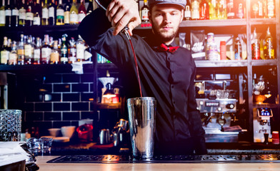 Bartender is making cocktail at bar counter. Fresh cocktails. 
