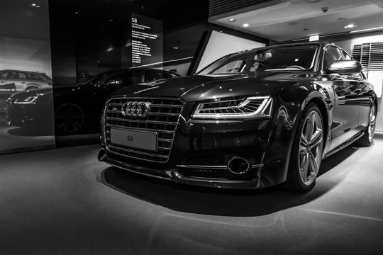 BERLIN - MARCH 08, 2015: Showroom. Full-size luxury car Audi S8. Black and white. Audi AG  is a German automobile manufacturer.