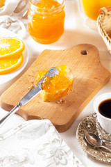 Orange jam with white bread on the table