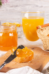 Orange jam with white bread on the table