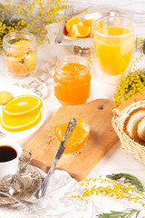 Orange jam with white bread on the table