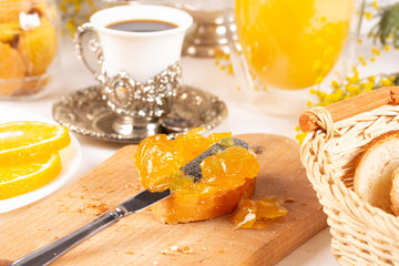Orange jam with white bread on the table
