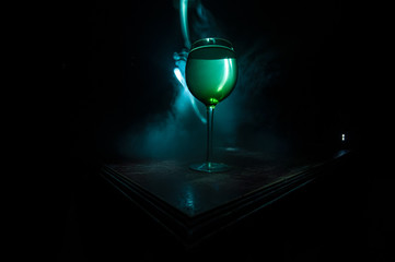 Goblet of white wine on wooden table on wooden wall background