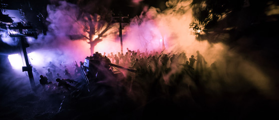 Fototapeta na wymiar War Concept. Armored vehicle silhouette fighting scene on war foggy sky background at night.