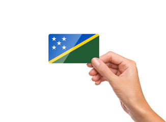Beautiful hand holding Solomon Islands flag card on white background
