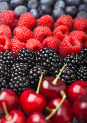 Fresh organic summer berries mix. Raspberries, strawberries, blueberries, blackberries and cherries. Macro. Close up