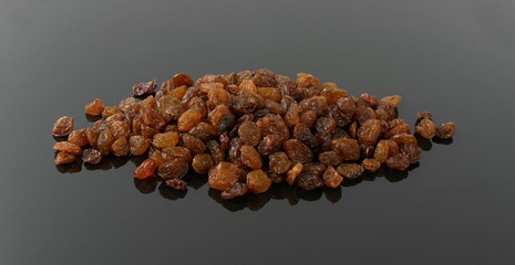 Obraz premium Heap of Dark Brown Sweet Raisins, Dried Grapes Pile