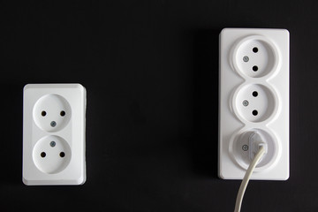 Two bright sockets on a black background in an upright position.