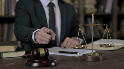 Close up Shoot of Judge Hand pointing Finger in Court Room Table