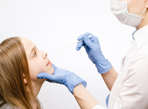 Pediatrician taking nasal mucus test sample