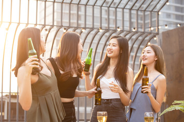 happy asian women party with beer in nightclub